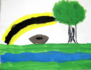 A yellow and black Steelers colors rainbow. a large tree, both over a football and green field with a stream running through it